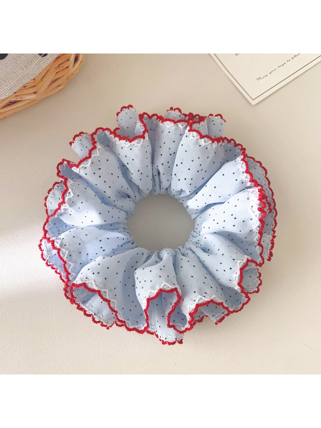 Gifty scrunchie displayed alongside matching hair accessories on a wooden surface