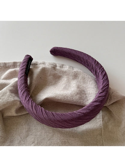 Side view of purple wide edge headband showing thickness and style