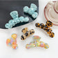 Beau elegant wavy hair claw clip in glossy tortoiseshell finish on white background