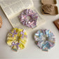Close-up of Gifty Ribbon Bow Plaid Scrunchie showing fabric texture and bow detail
