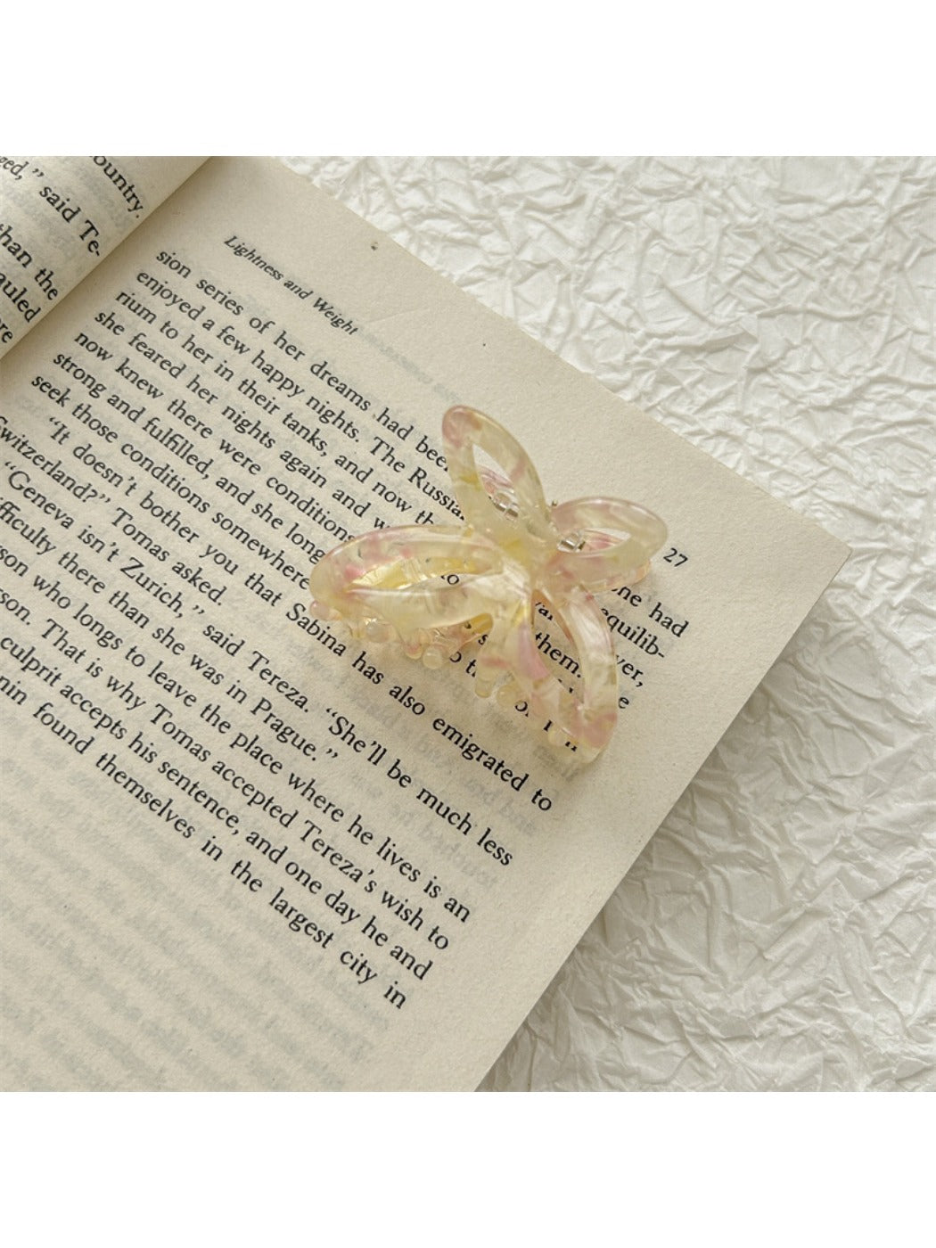Beau acetate butterfly shaped claw clip positioned to highlight butterfly wings design