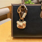 Bear charm keychain held in a hand to show size and texture