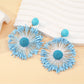 Detailed close-up of the intricate firework pattern on the earrings