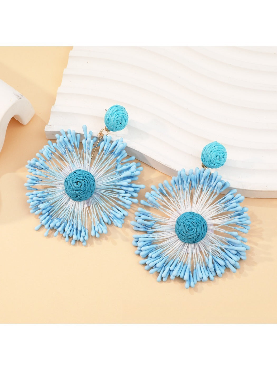 Detailed close-up of the intricate firework pattern on the earrings