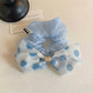 Close-up of polka dot bow decoration on elastic hair tie