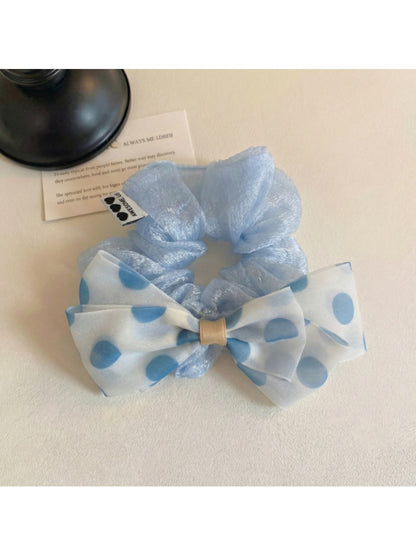 Close-up of polka dot bow decoration on elastic hair tie