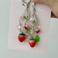 Close-up of the Sweet Tulip Strawberry keychain showing detailed strawberry texture and green leaves