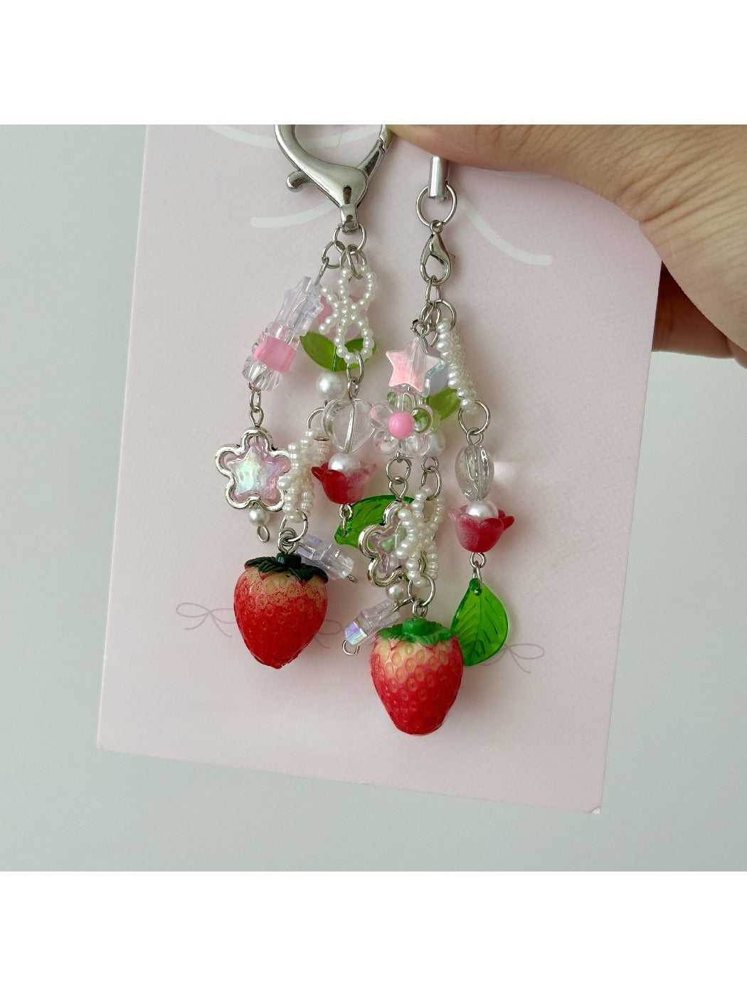 Close-up of the Sweet Tulip Strawberry keychain showing detailed strawberry texture and green leaves