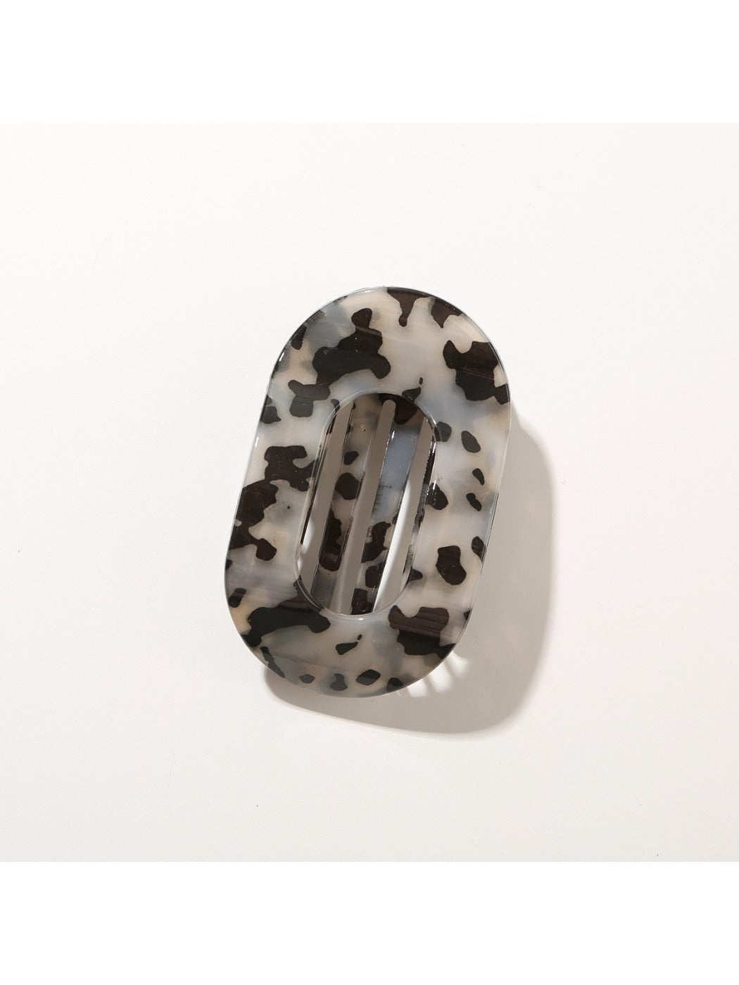 Beau hair clip resting on fabric surface to contrast colors and texture