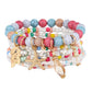 Multiple Lovra bracelets stacked on wrist showing variety of bead colors