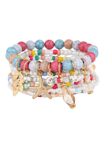 Multiple Lovra bracelets stacked on wrist showing variety of bead colors