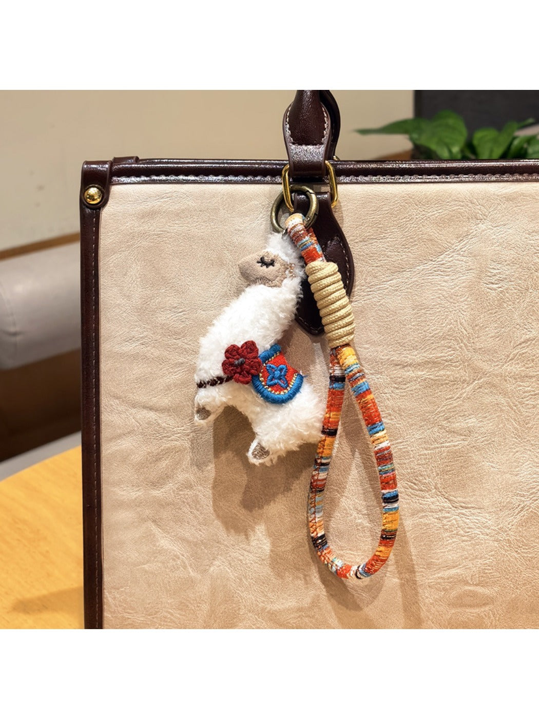 Top view of the alpaca keychain highlighting its round eyes and small ears