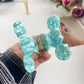 Beau hair claw clip holding thick wavy hair in an updo style