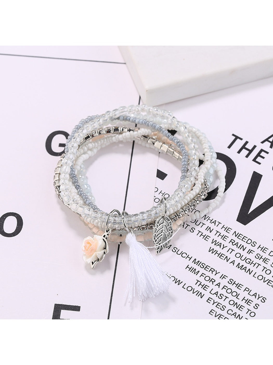 Close-up of Lovra bracelet showing detailed multi-row beaded design and tassel