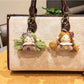 Vintage girl charm keychain displayed hanging from a set of keys on a wooden surface