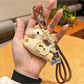 Keypus pony charm keychain photographed with natural lighting highlighting pastel colors