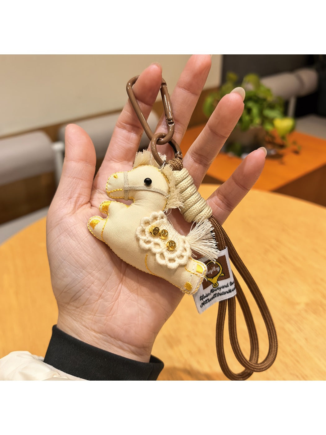 Keypus pony charm keychain photographed with natural lighting highlighting pastel colors