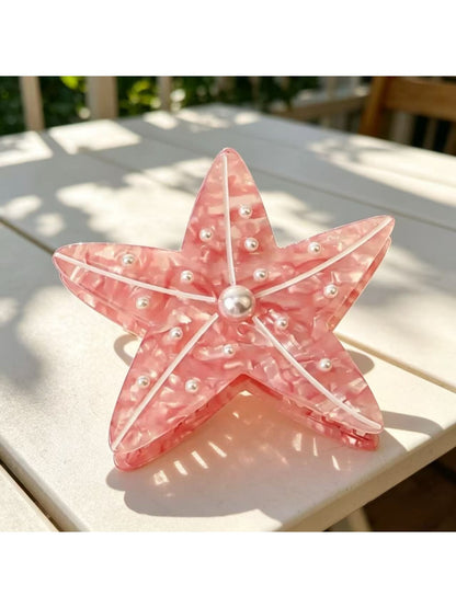 Side view of pastel pink Beau sea animal claw clip showing curved edges