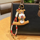 Bear keychain lying flat showing the back and flower stem