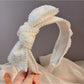 Fashionable beaded bow headband in black, perfect for chic and elegant looks