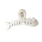 Beau fishbone acetate hair clip held in hand showing size and shape