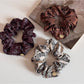 Close-up of Gifty gentle artistic printed scrunchie with soft pastel floral design