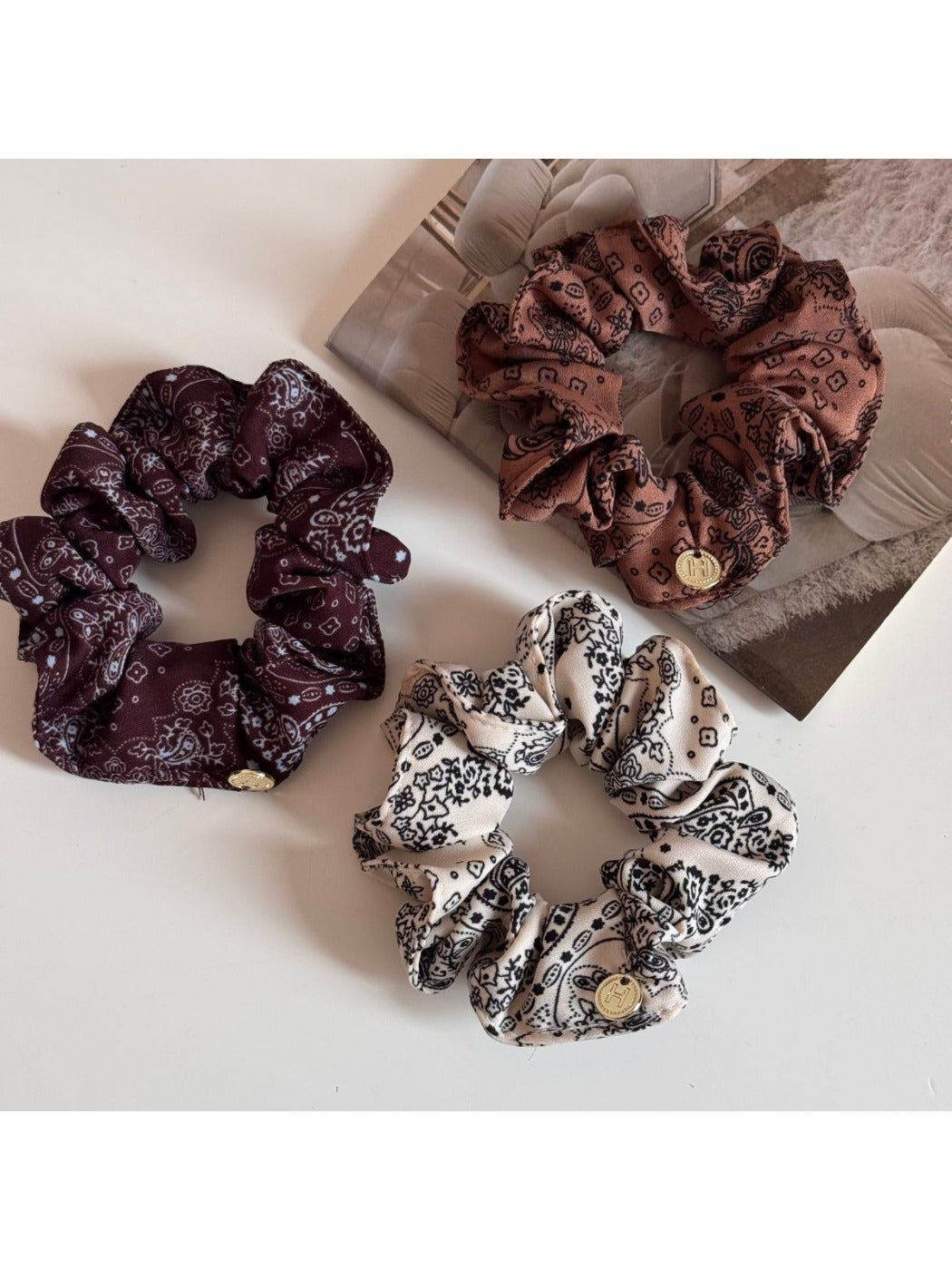 Close-up of Gifty gentle artistic printed scrunchie with soft pastel floral design