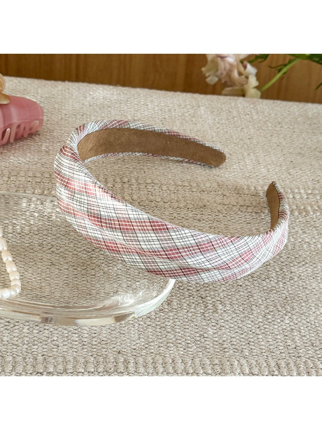 Gifty headband wrapped around wrist, highlighting minimalist plaid and stripe pattern