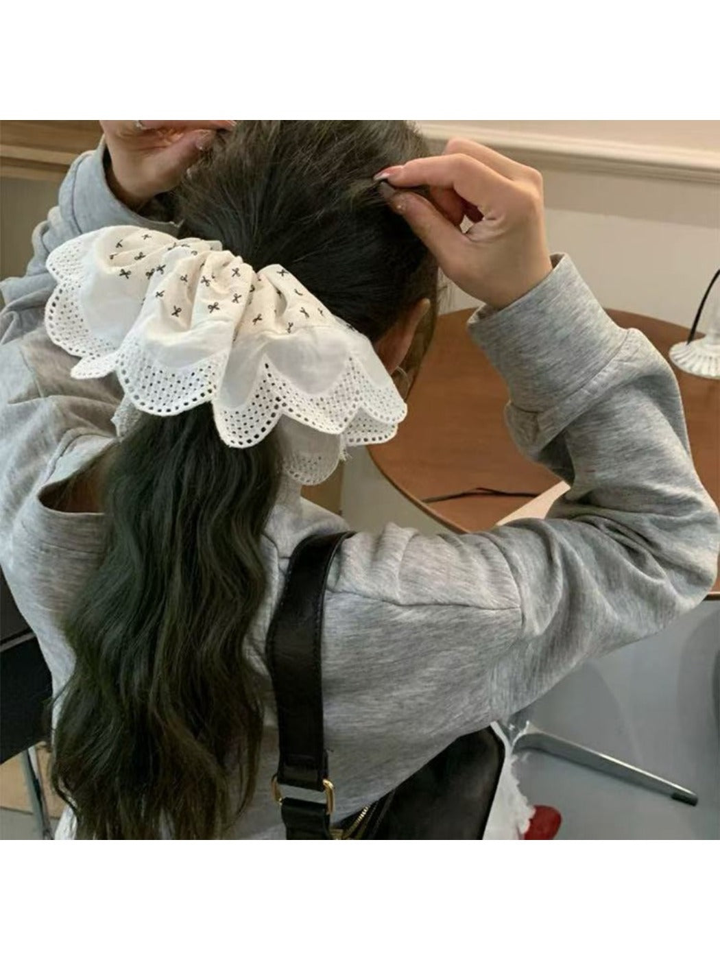 Gifty scrunchie styled on a wrist, displaying colorful patchwork fabric