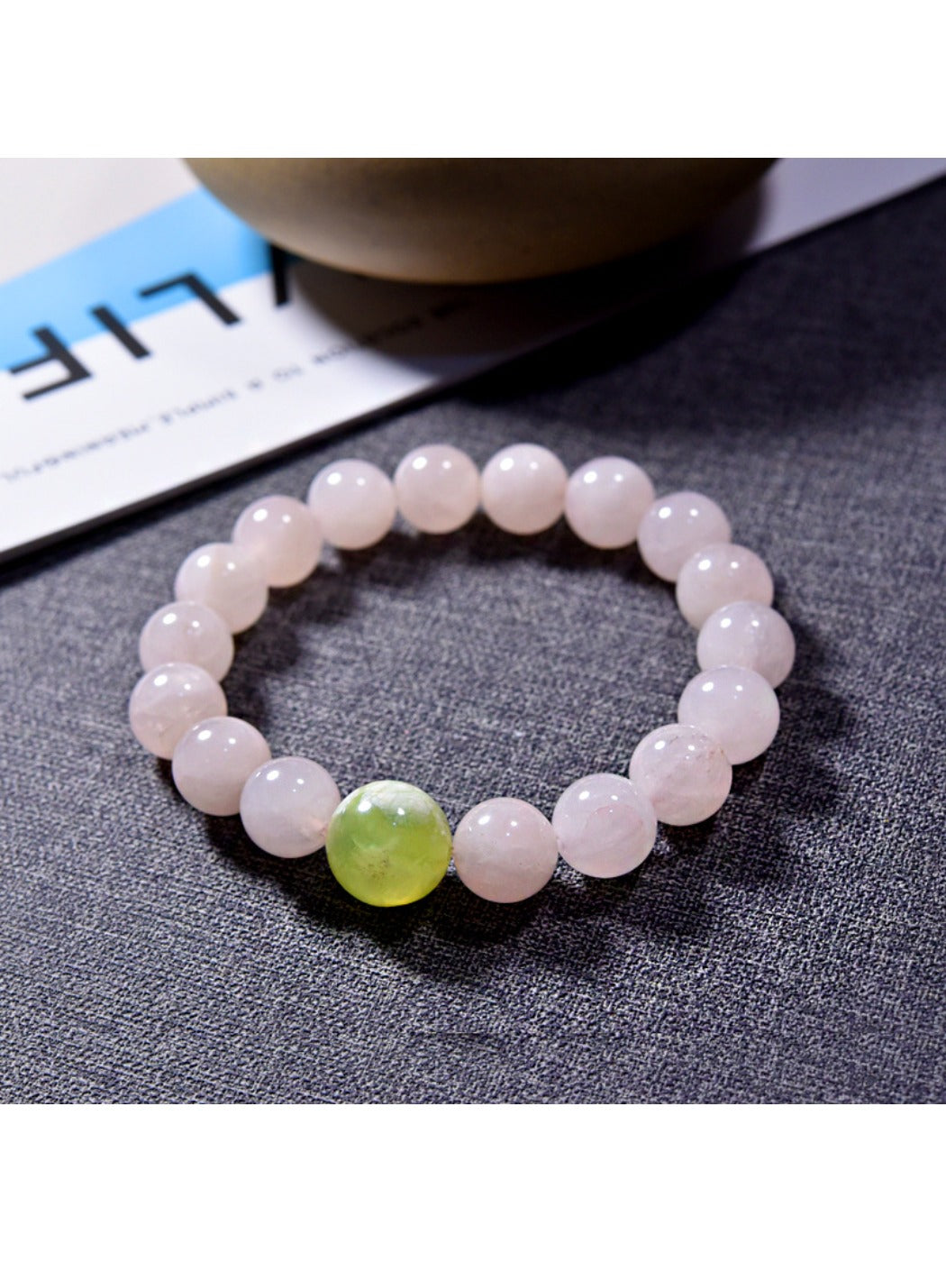Close-up of Lovra minimalist pink crystal beaded bracelet on a white background