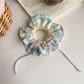 Gifty scrunchie headband wrapped around a wrist as a fashion accessory