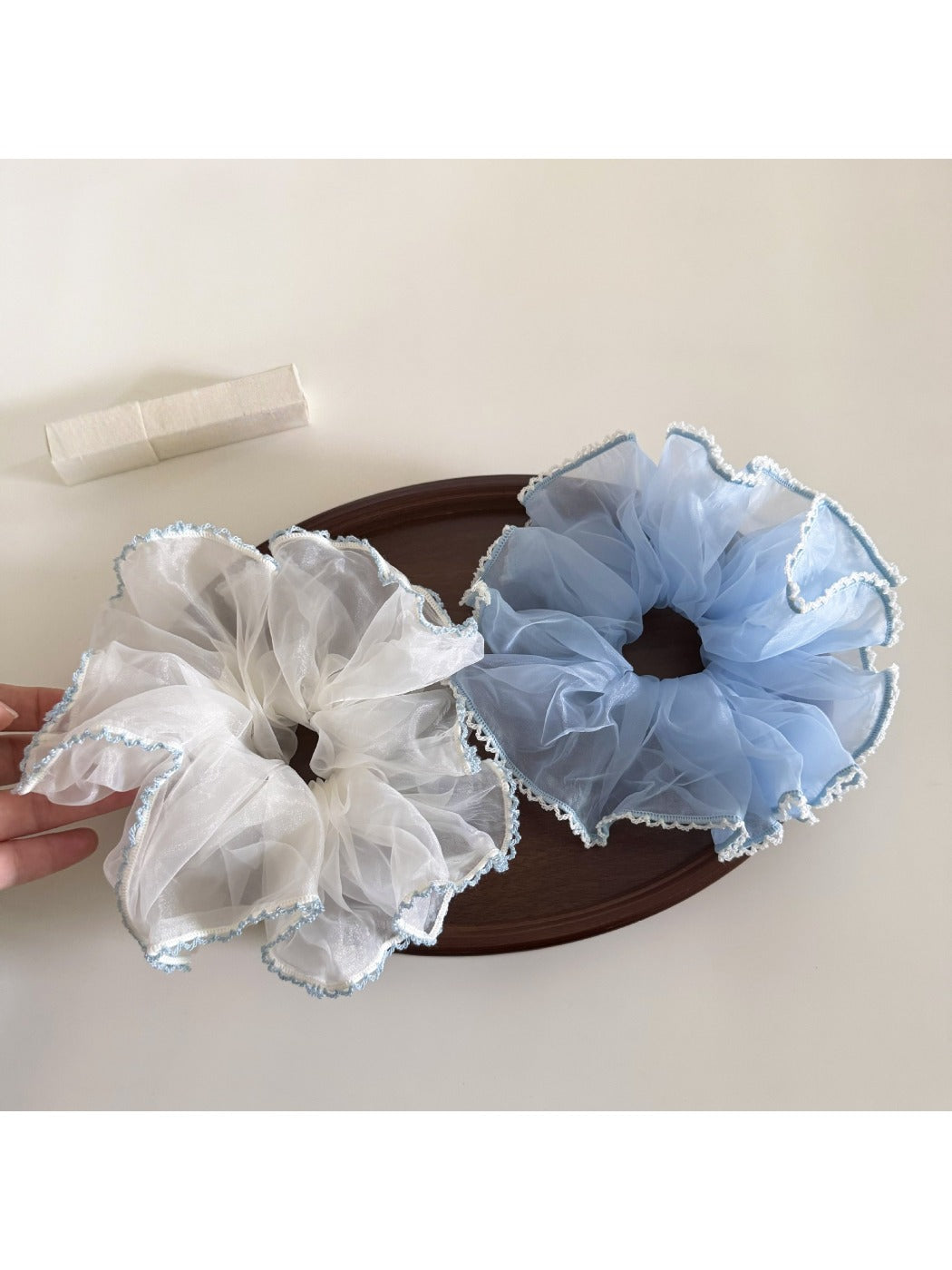 Gifty scrunchie styled in a ponytail on dark hair