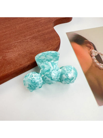 Beau hair claw clip holding thick wavy hair in a casual half-up style