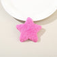 Beau star hair clip with visible metal clip backing on a plain white background