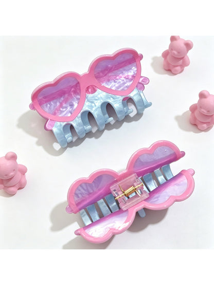 Beau claw clip shaped like eyeglasses holding hair in a bun