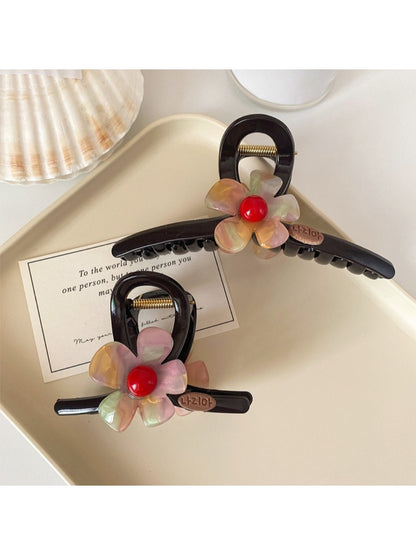 Close-up of beige Beau claw clip showing crisscross flower pattern