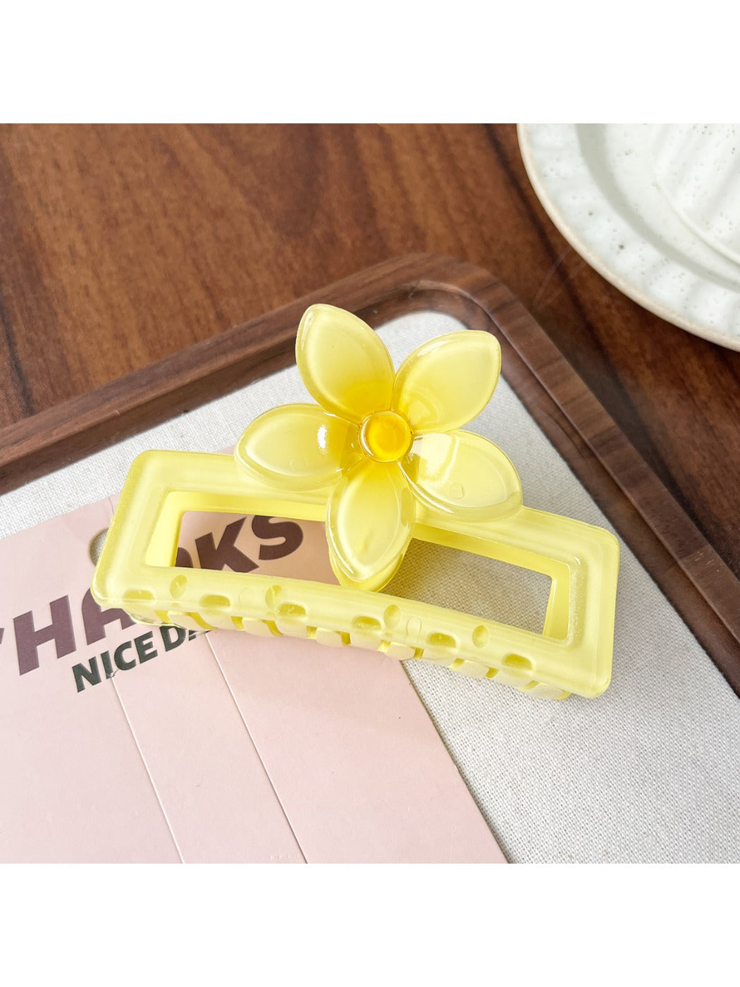 Beau square ombre flower shaped claw clip with open clasp revealing inner teeth and hinge
