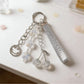 Minimalist cherry charm keychain with silver ring on white background
