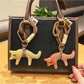 Fox charm keychain hanging from a backpack zipper pull