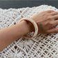 Lovra vintage ombre bangle bracelet resting on textured surface