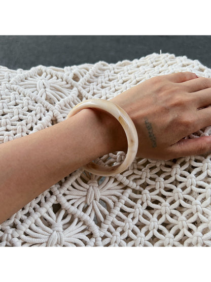 Lovra vintage ombre bangle bracelet resting on textured surface
