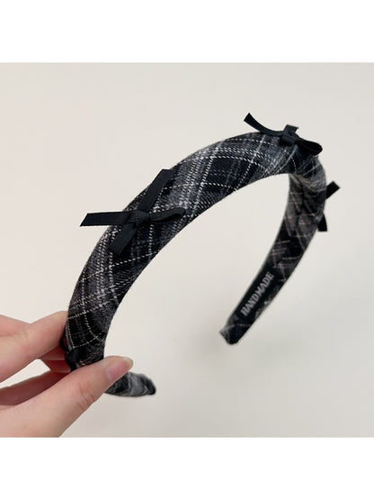 Gifty plaid bow headband folded to show flexibility and material
