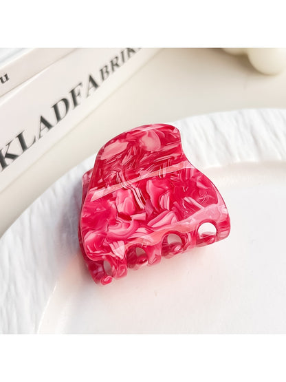 Beau elegant half moon claw clip resting on wooden surface