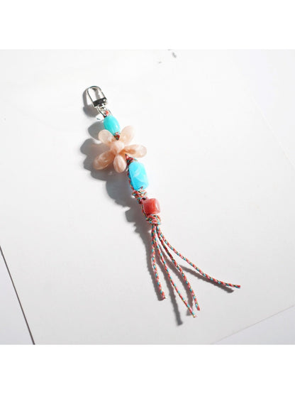 Keypus acrylic beaded flower keychain displayed on a wooden surface