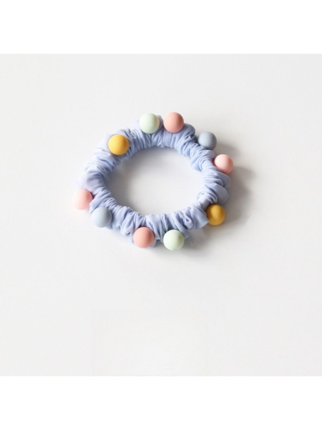 Close-up of pink and purple beaded hair ties showing bead details and elastic bands
