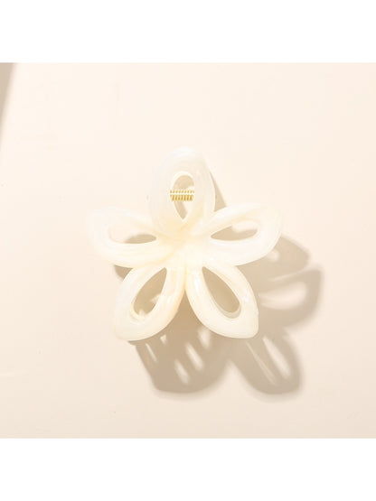 Top view of Beau openwork flower hair clip with bright, varied colors