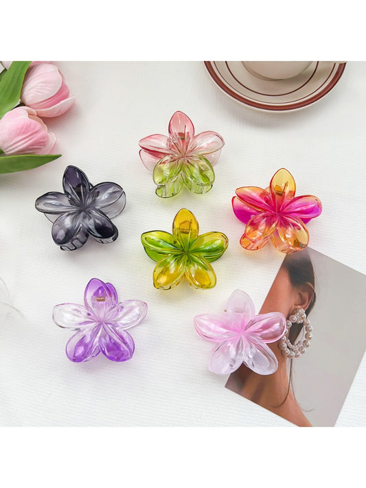 Beau colorful flower shaped claw clip with pink and yellow petals on white background