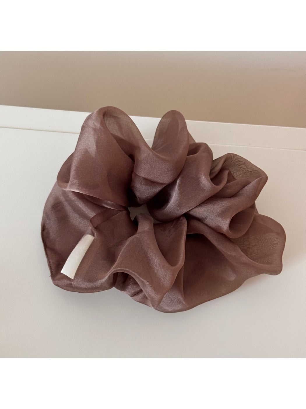 Soft romantic aesthetic scrunchie displayed with complementary accessories