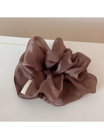 Soft romantic aesthetic scrunchie displayed with complementary accessories