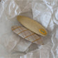 Beau colorful oval hair clip clipped into brown hair from a side angle